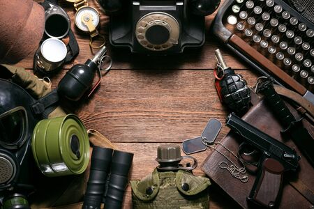 Post apocalypse soldier equipment on the wooden table background concept.の写真素材