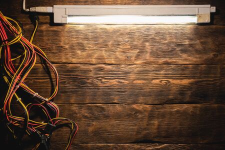 Computer power supply wiring on the wooden table flat lay background.の写真素材