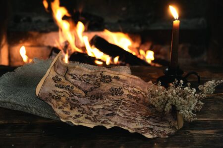 Treasure map over a burning fire background. Treasure hunt concept.の写真素材