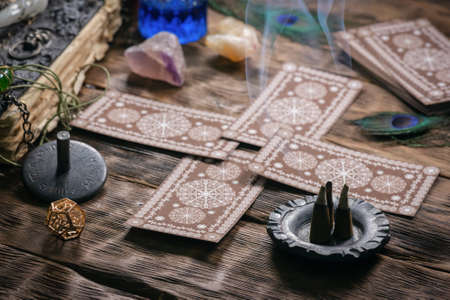 Tarot cards on the wooden table background.の写真素材