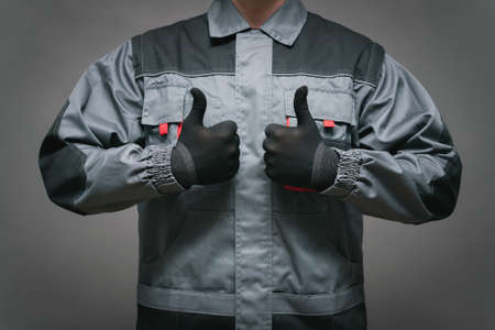The worker is showing a thumbs up gesture close up.の写真素材