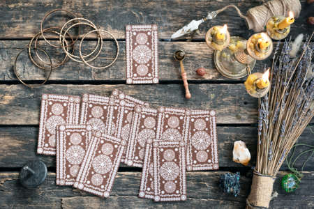 Tarot cards deck on the old wooden table background.の写真素材