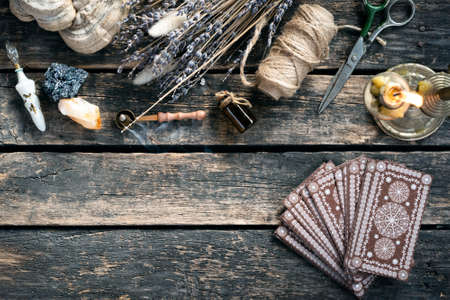 Tarot cards deck on the old wooden table background.