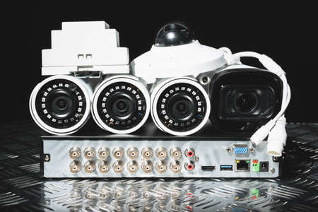 Modern white security cameras and video recorder close up. Video surveillance concept background.の写真素材