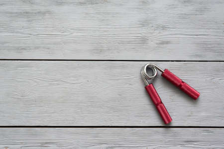 Carpal expander on a wooden flat lay background with copy space.の写真素材