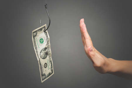 Woman hand is showing a stop gesture by her hand close up. Refusal to bribe concept.の写真素材