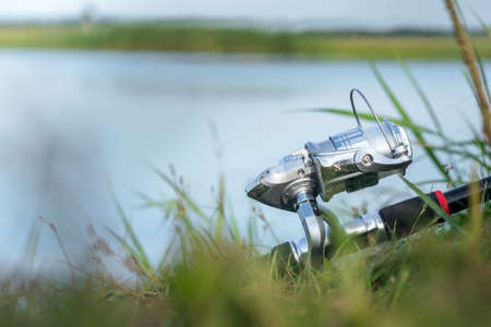 Fishing rod on the lake shore close up.の写真素材
