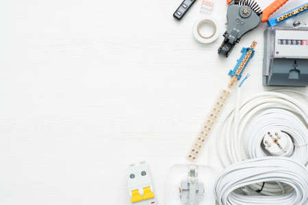 Electrical equipment and accessories on the white workbench background with copy space.の写真素材