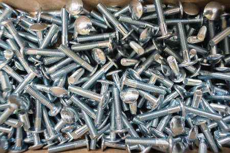 Heap of bolts in the box top view background.