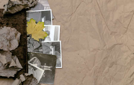 Vintage photo album book laying in fallen autumn leaves and retro photos of peoples with no faces on...