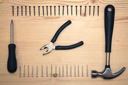 Screwdriver and screws. Hammer and nails. Construction tools flat lay design.