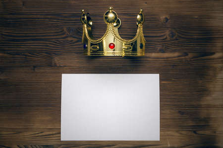 VIP agreement. Premium contract. Special offer. Blank paper sheet and golden crown on wooden table...