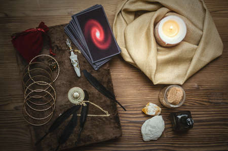 Tarot cards deck and book of magic on fortune teller desk table bakground. Future reading concept.の写真素材