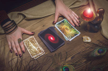 Woman fortune-teller chooses a deck of cards for divination.