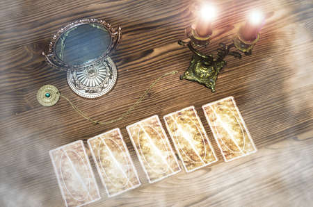 Tarot cards on wooden table. Fortune teller.