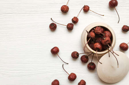 Herbal medicine. Alternative medicine concept. Dry organic natural ingridients. Scattered wild berry...