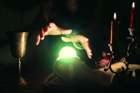 Crystal ball and fortune teller hands. Divination. Seance.