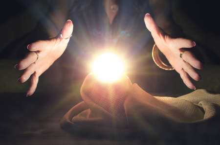 Crystal ball and fortune teller hands. Divination. Seance.