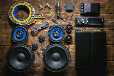 A new car audio equipment on brown wooden workbench background with copy space.の写真素材
