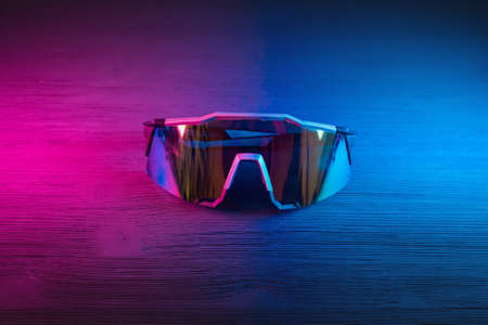 Sport glasses on the table close up in neon lights background.の写真素材