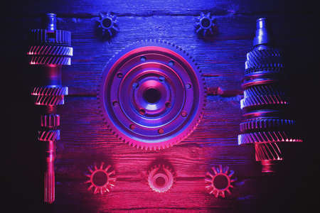 Primary and secondary shaft of the car gearbox on black background in the neon lights. Car service background. Gearbox repair.の写真素材
