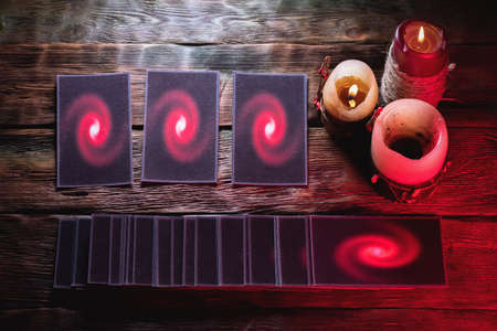 Tarot cards deck on the old table background.