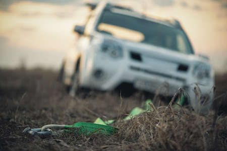 Towing hook with a rope and car stuck in the mud.の写真素材