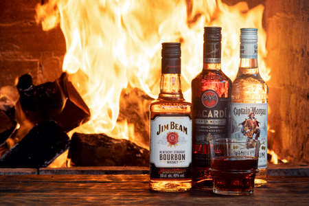 Moscow, Russia - June 30, 2019: Bacardi, Jeam Beam and Captain Morgan bottles on the wooden table.のeditorial素材