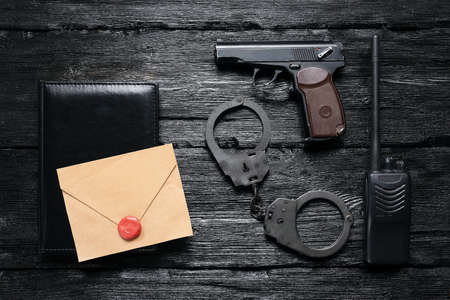 A top secret letter and detective agent accessories on the black desk background.の写真素材