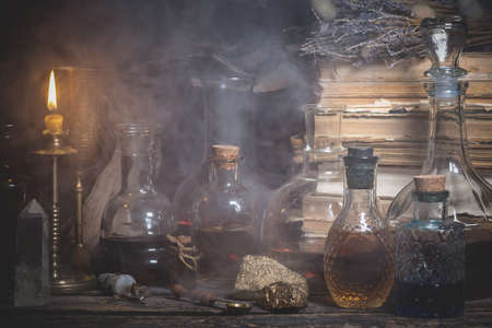 Magic potions on the alchemist table background.