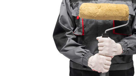 Paint roller in house painter hands isolated on the white background.