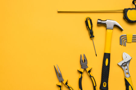 Construction tools on the yellow flat lay background with copy space.の写真素材