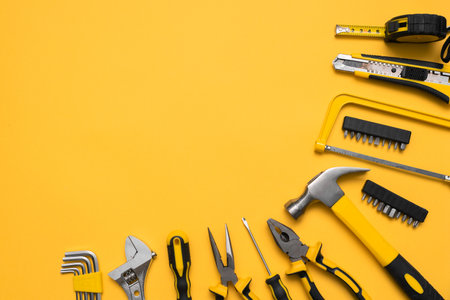 Construction tools on the yellow flat lay background with copy space.の写真素材