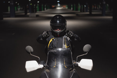 Motor biker is showing ahead by his index finger close up.の写真素材