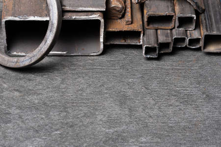 Black metal profile tubes on the black background.の写真素材