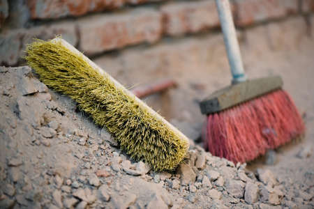 Broom on the dusty construction site floor background.の写真素材