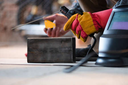 Welder is welding a metal frame close up.の写真素材