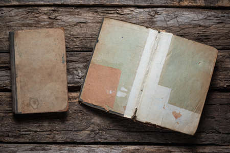 Open old book on the wooden desk table flat lay background.の写真素材