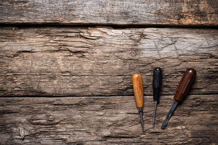 A screwdrivers on the old wooden table background with copy space.の写真素材