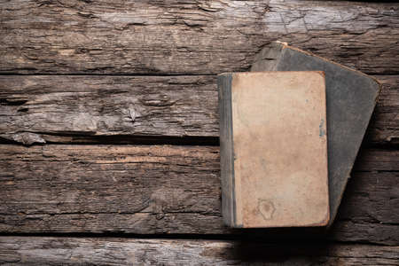 Open old book on the wooden desk table flat lay background.の写真素材