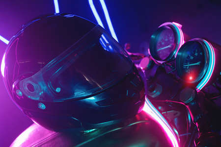 Black motorcycle helmet in the neon lights. Motorbike store showroom concept.の写真素材