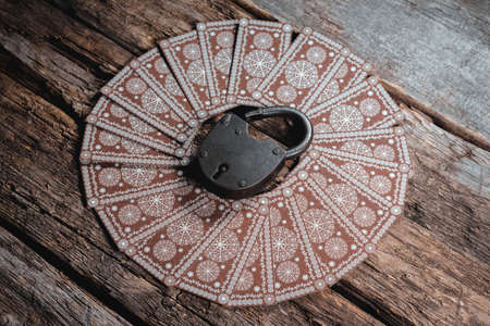 Tarot cards and old padlock on the wooden table background. Hidden future.