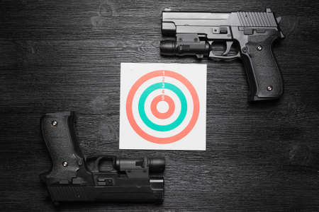 Gun and paper target. Shooting range concept. Shooting practice background.の写真素材