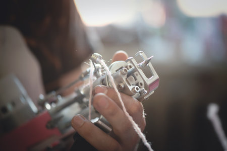 Tuft gun in the master hands close up background.