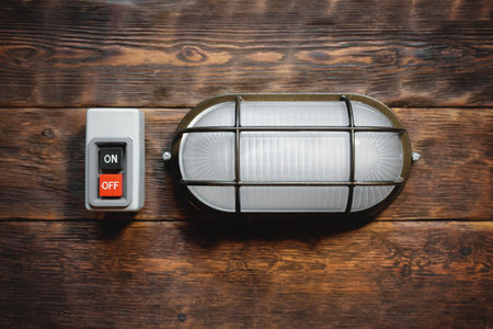 Electric works concept flat lay background with copy space. Electric light lamp and switch on the...