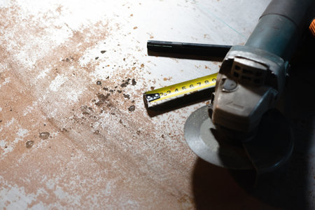 Construction meter tape, marker and angle grinder close up background.の写真素材