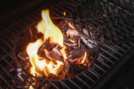 Burning flame in the barbecue grill brazier close up background. Top view.の写真素材