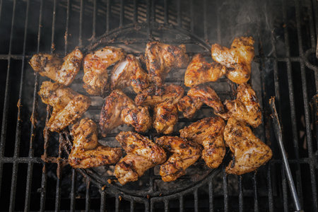 Chicken wings on the barbecue grill close up background.の写真素材