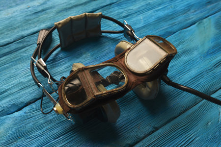 Retro style pilot goggles and headset on the blue sky concet background.の写真素材