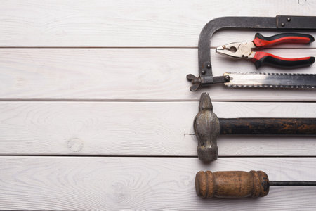 Construction concept background. Building work tool on the wooden workbench background. Top view....